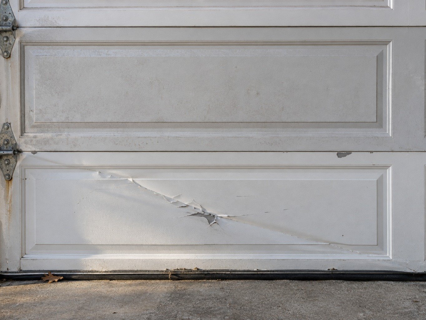 Replacement garage door section being fitted